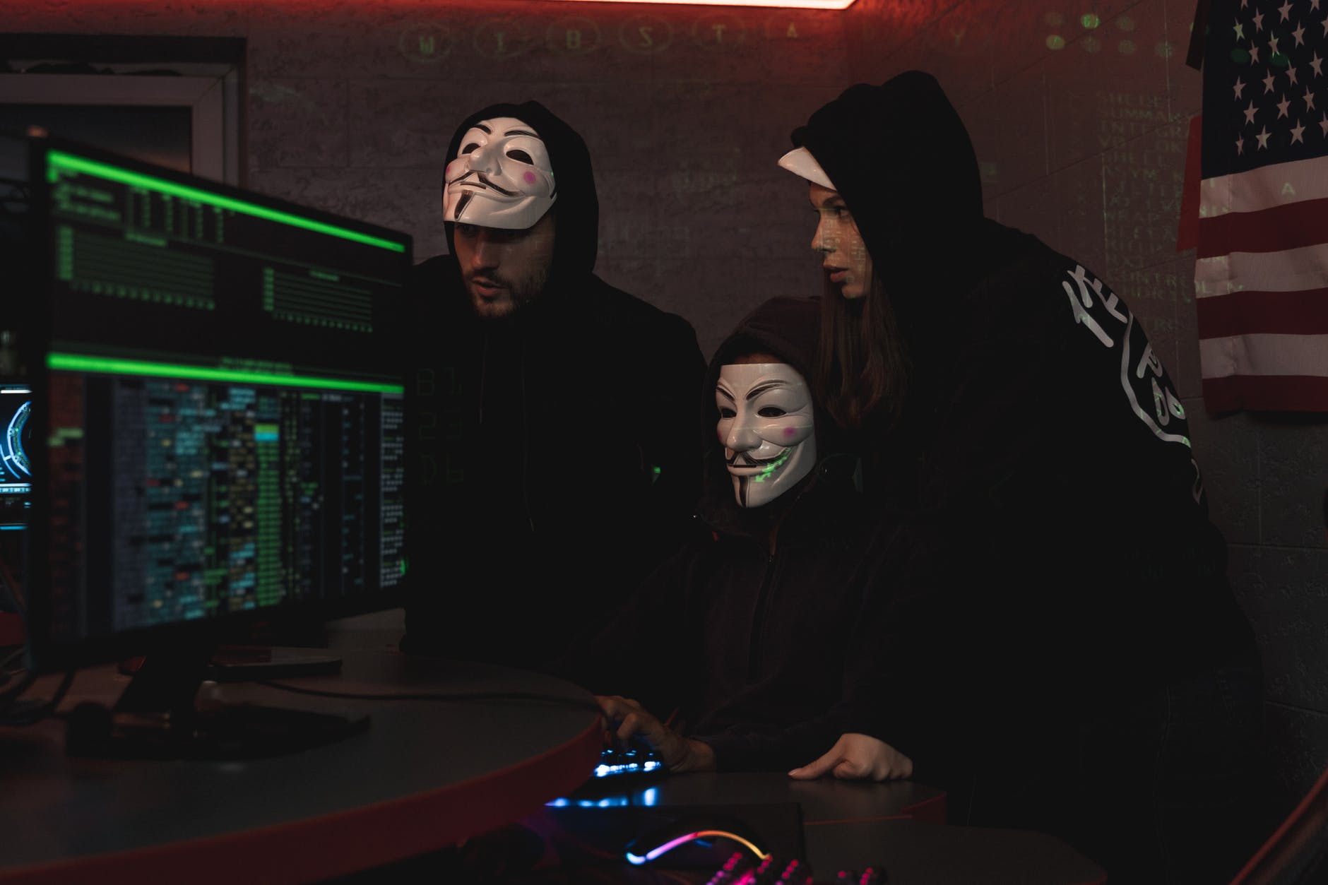 three people hacking a computer system